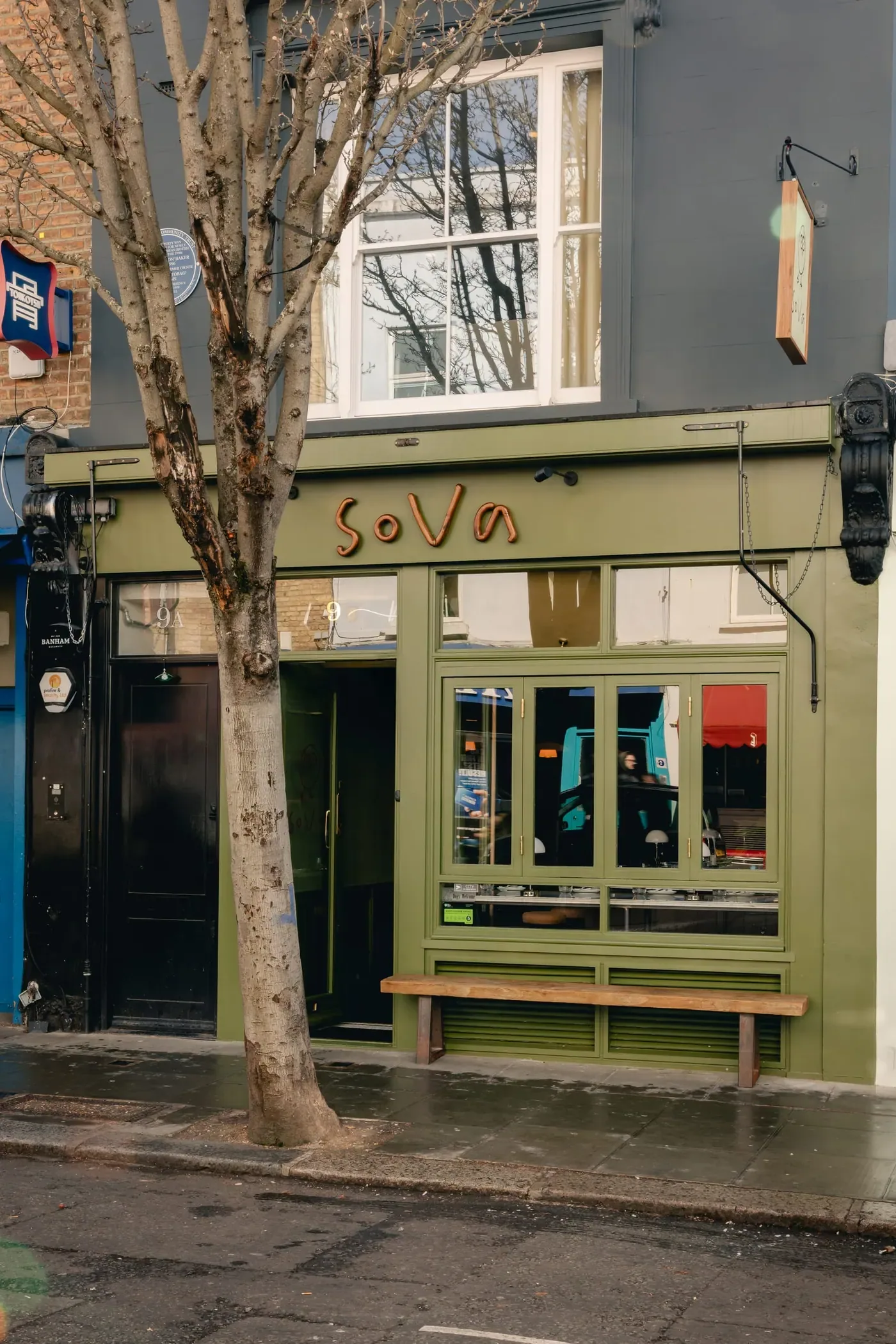 The olive green shopfront of sova on Blenheim Crescent, the hand-drawn wordmark above the window.