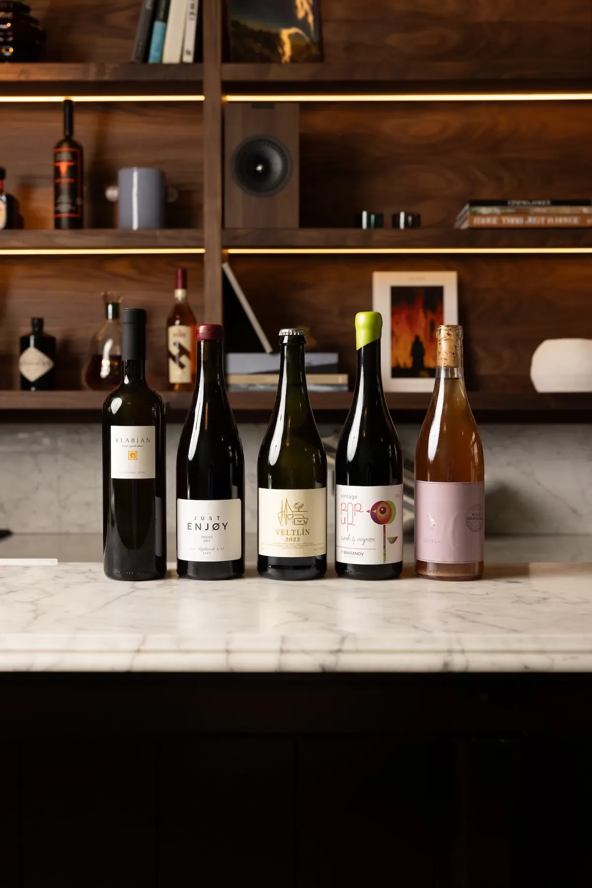 A lineup of open bottles on the marble pass.